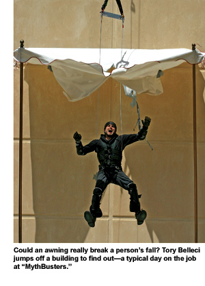 Alumnus Tori Belleci parachutes from a tall building and crashes through an awning below.