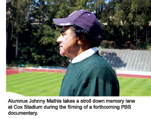 Johnny Mathis gazes down on the track from a high post in the stands at Cox Stadium.