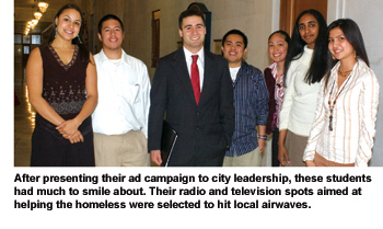 A group of students, each smiling and dressed professionally, gather in a hallway in City Hall after presenting their ad campaign to Mayor Gavin Newsom.