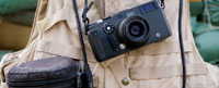 A close up of a camera and Kevlar vest