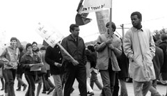 Photo of strikers with picket signs, Danny Glover on far right.