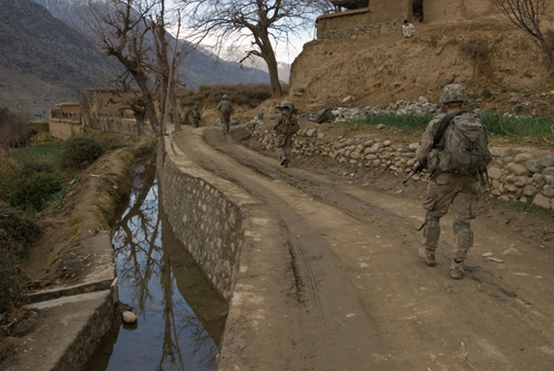 International Security Assistance Force platoon follows a patrol led by the Afghan National Army through the village of Shamaser Kalay.
