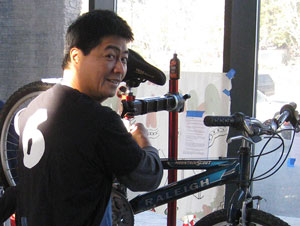 Joseph Hui working on a bike