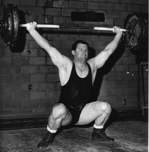 Jim Schmitz as a student athlete lifting weights