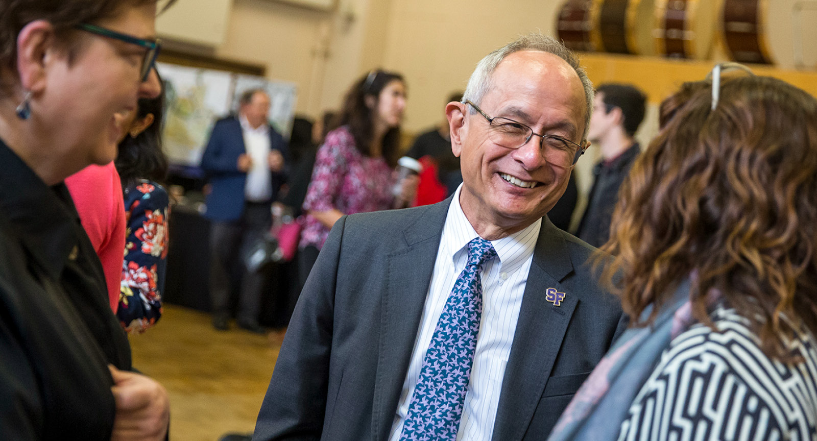 President Leslie E. Wong talking with SFSU staff