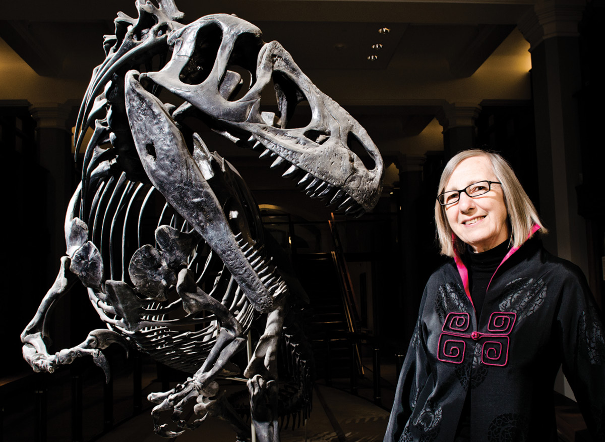Gerta Keller standing in front of a dinosaur skeleton