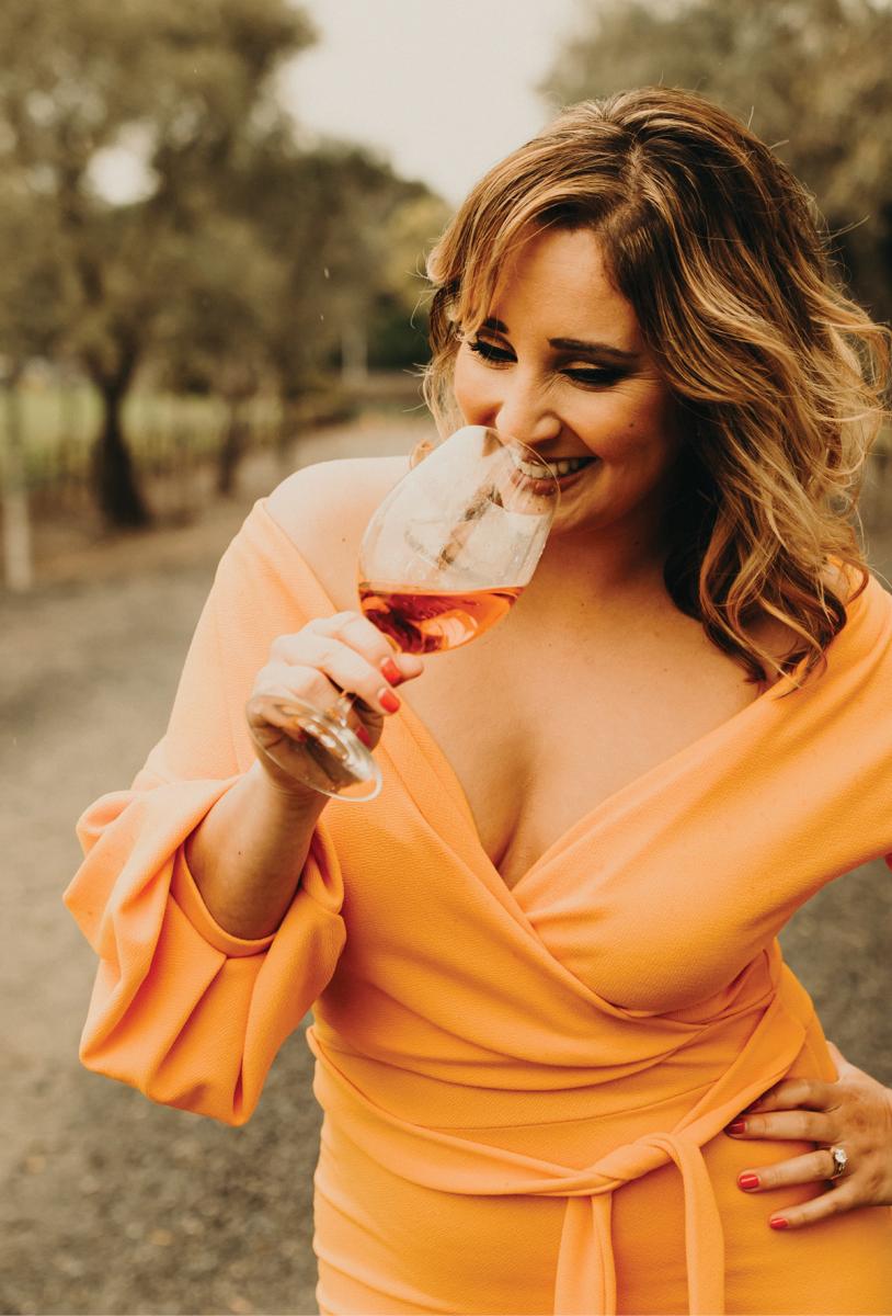 Dalia Ceja holding a glass of wine near her mouth