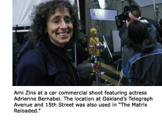 Oakland film coordinator Ami Zins smiles from her post behind the cameras of a car commercial shoot featuring a young actress.