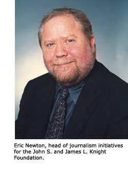 A head shot of Eric Newton wearing a suit and tie.