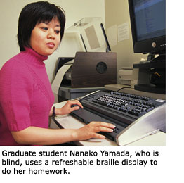 SFSU student Nanako Yamado, who is blind, is running her fingers along the bottom of the keyboard of a refreshable Braille display inside the Maurice K. Schiffman Room in the lower level of the J. Paul Leonard Library.