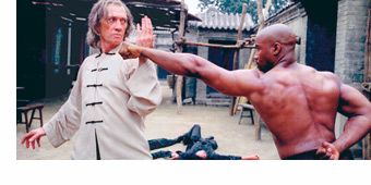 Alumnus David Carradine blocks a martial arts move from an opponent on the set of “Kill Bill.”