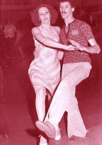 Two students in polyester clothes take part in disco dance lessons on campus.