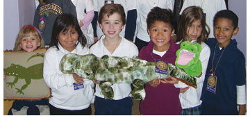 Six smiling first-graders hold stuffed aligators sporting SF State logos.
