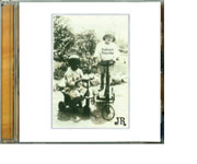 A vintage photo of children at play-- one seated on a tricycle the other astride a scooter, illustrates the cover of Jeff Rosedale's CD, "Ooboo's Pancake."