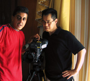 Arthur Dong and "Hollywood Chinese" cameraman Allan Barrett look through a video camera together