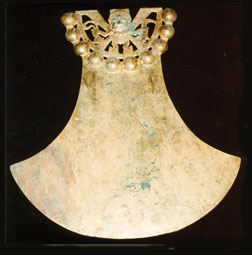 Photo of a gold Peruvian artifact called a backflap.
