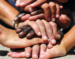 Close-up image of a sports huddle hand-stack