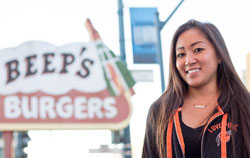 Samantha Wong in front of the sign for Beep's Burgers, her new restaurant located near SF State