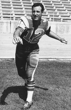 Twice all-conference quarterback, Donald McPhail posing in his football uniform