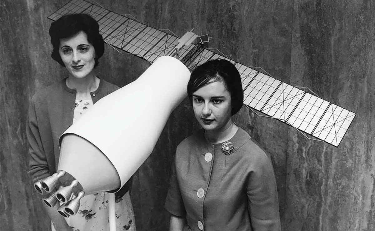 Female Scientists holding up a model satellite