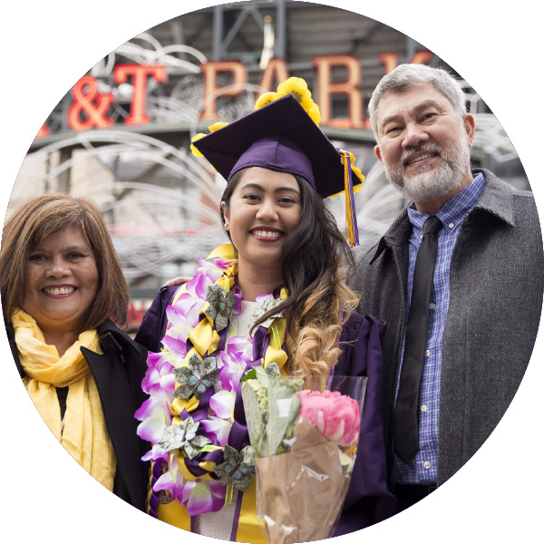 Girl in purple regalia with what appears to be her parents