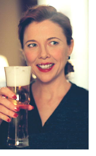 Annette Bening as Julia Lambert kicks back with a beer in this scene shot during filming