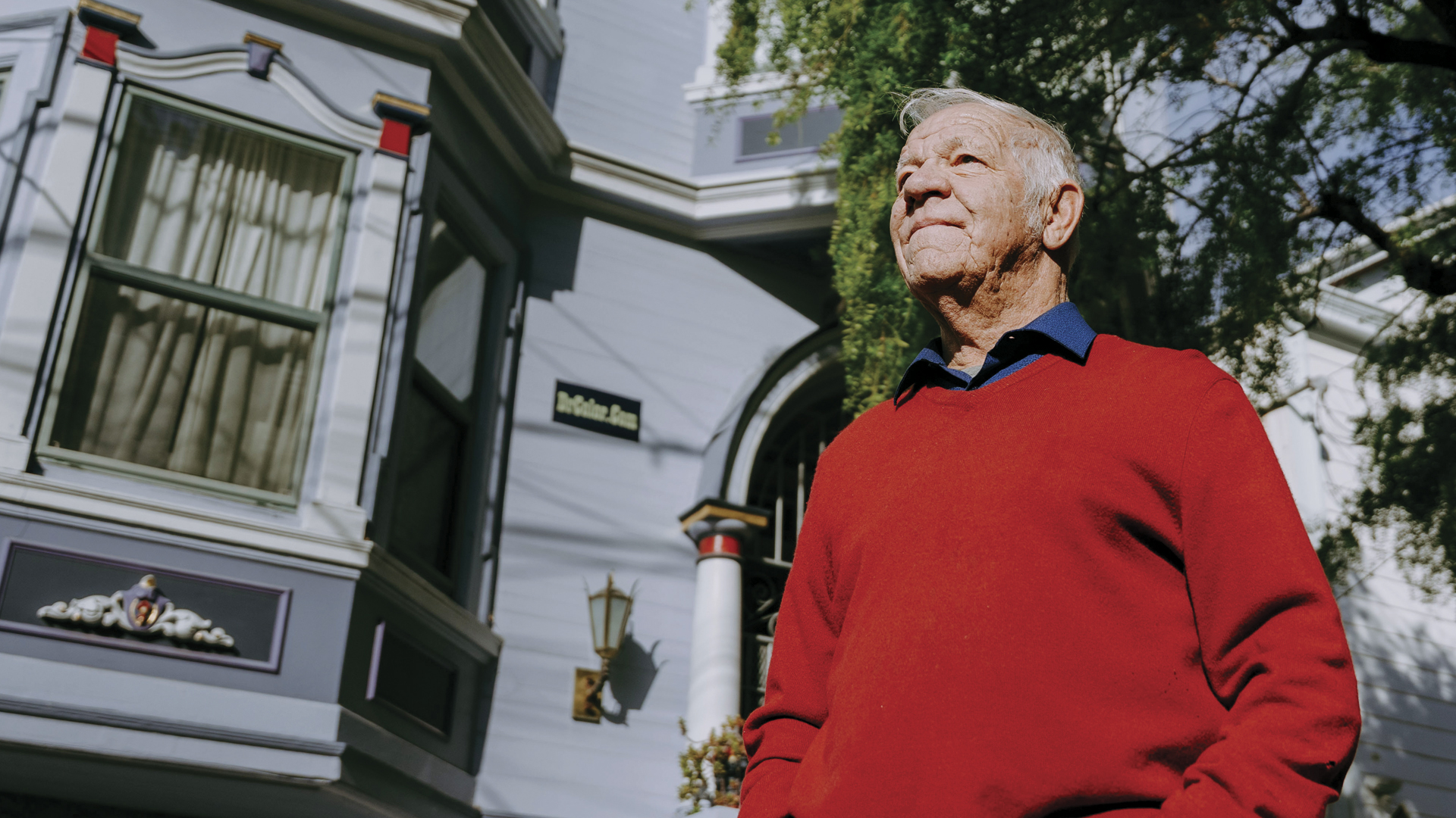 Bob Buckter with hands in pockets infront of Victorian homes