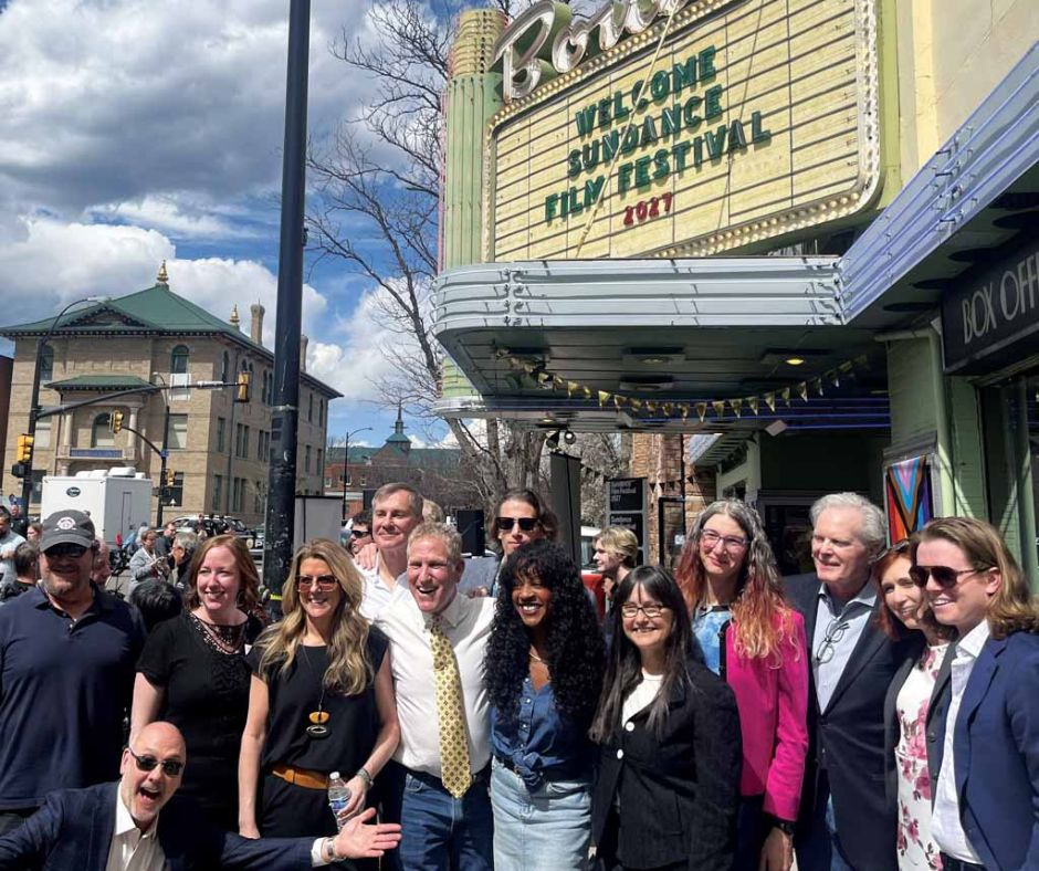 Group assembled in front of movie theatre film festival