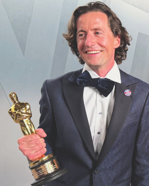 Conall Jones holding up his Academy Award for best Documentary Short