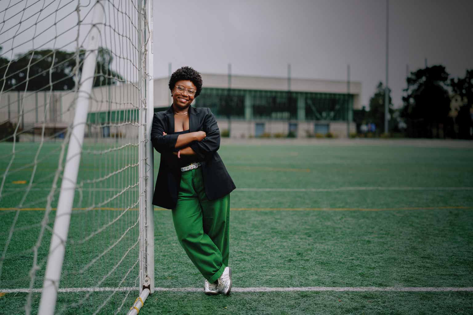 Tamerra Griffin leans on soccer goal post by Mashouf