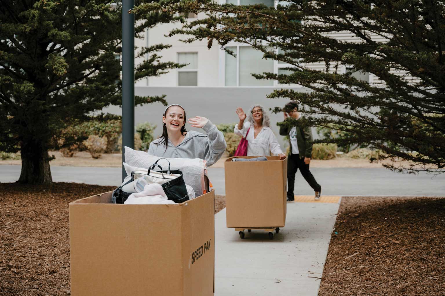 Junior students pushing their bins for move in day