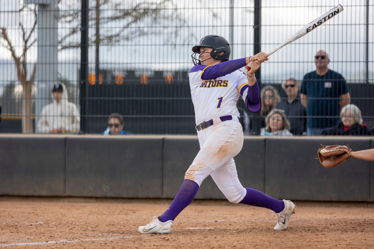 Gator softball player swinging the baseball bat