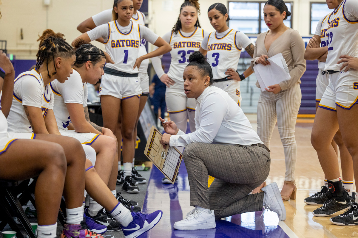 Women's basketball team listening to the head coach