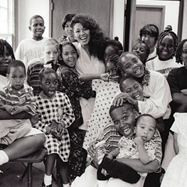 Janice Mirikitani smiling with a classroom of children