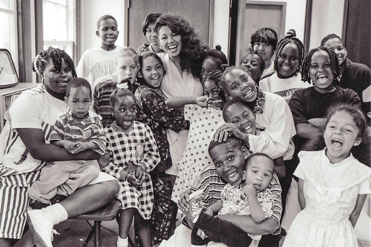 Janice Mirikitani smiling with a classroom of children