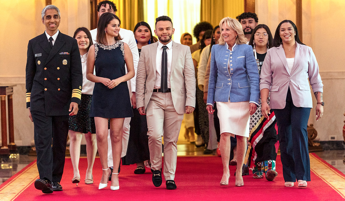 Juan Acosta walking with a group of well dressed people