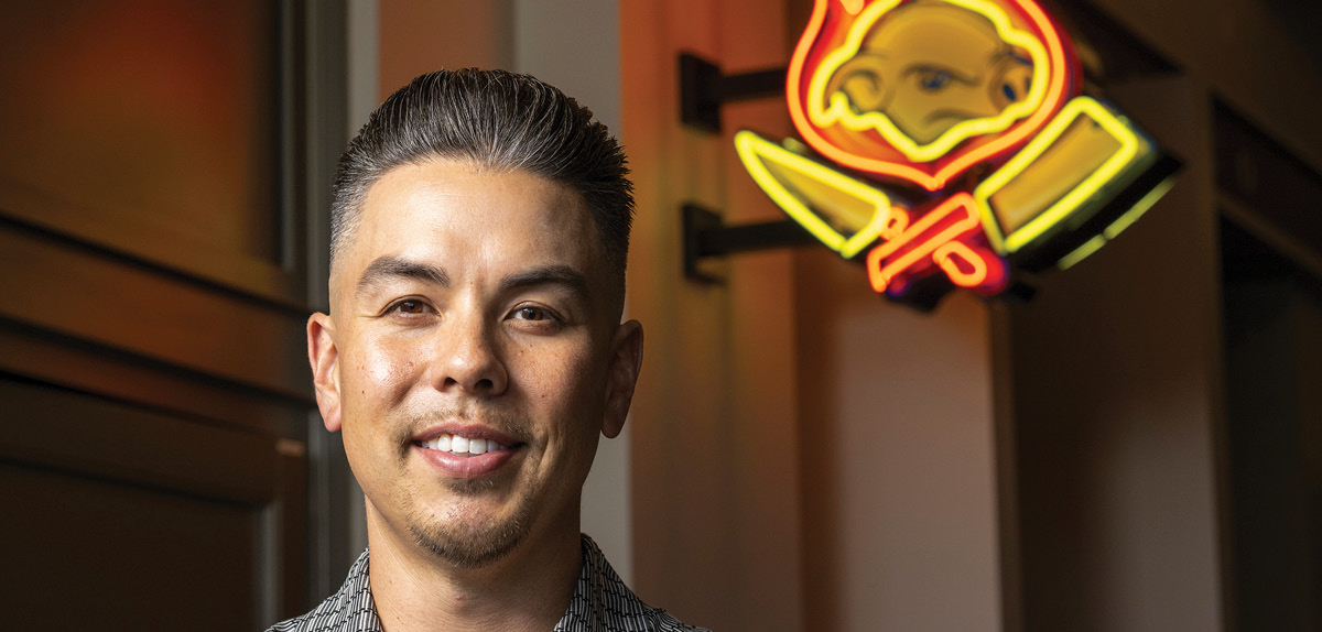 Evan Kidera standing in front of his restaurant, Señor Sisig.