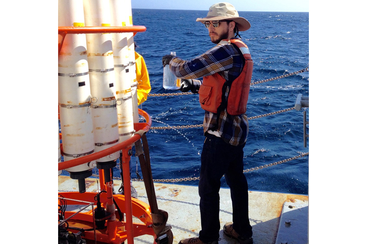 Charles Wingert holding a jug of ocean water