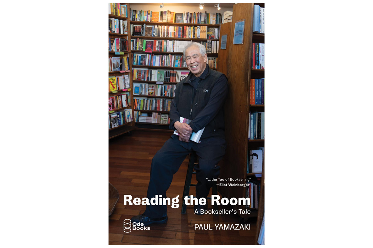 book cover of a man sitting on a stool in a bookstore