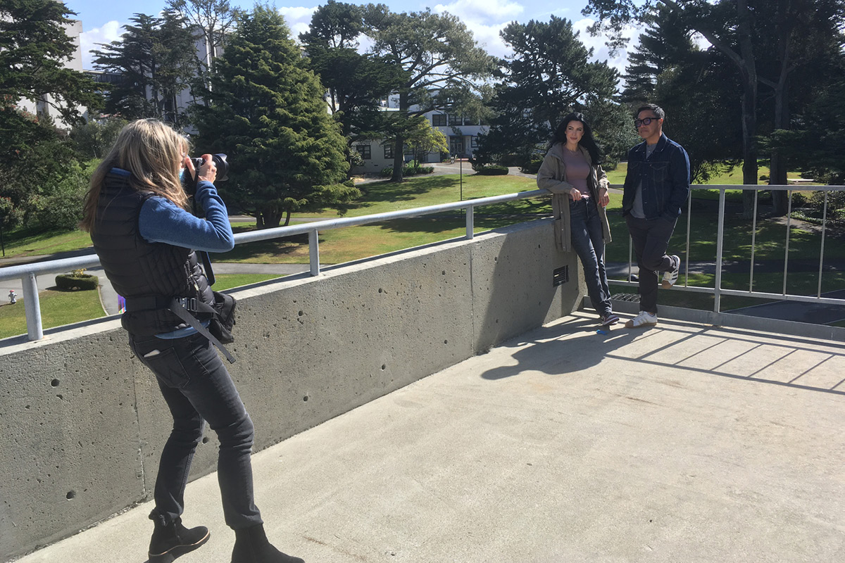 woman photographing a man and woman