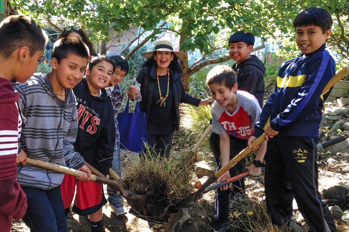 Bonnie Ora Sherk with kids shoveling