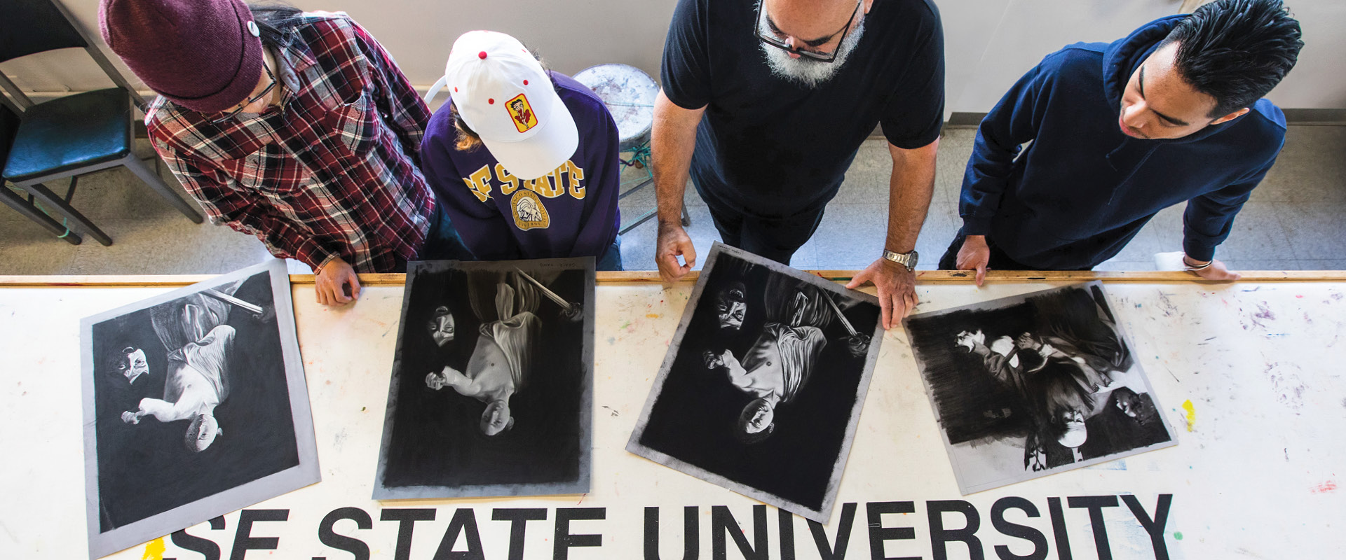 Top down view of professor working with students with art