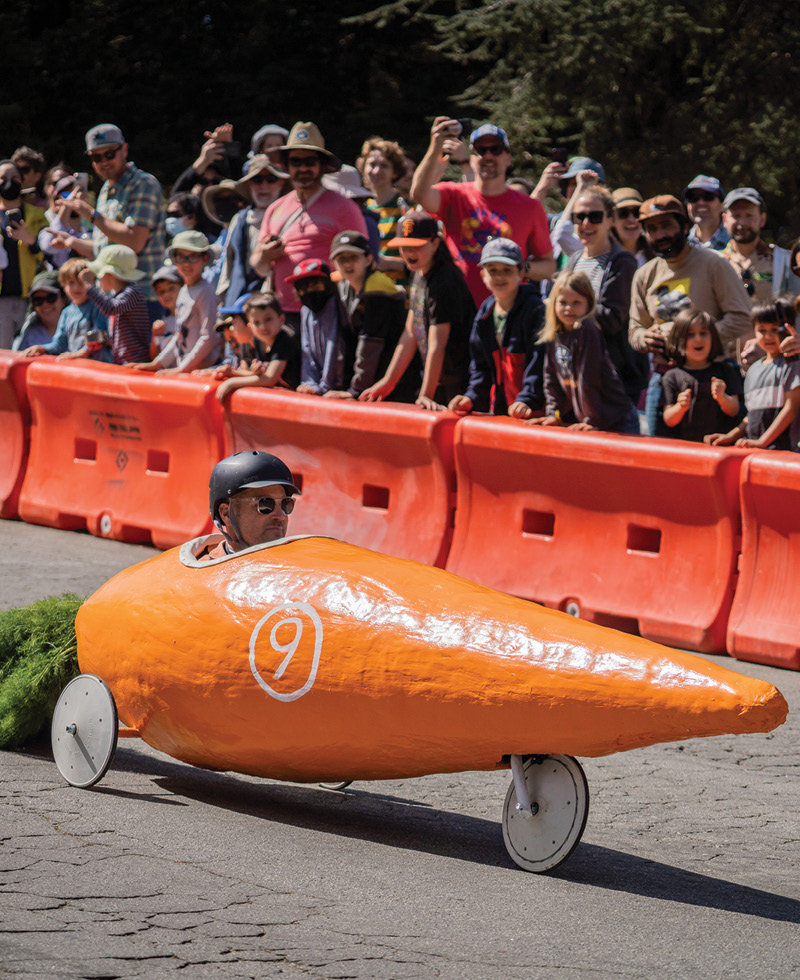 Man driving a carrot soapbox derby vehicle