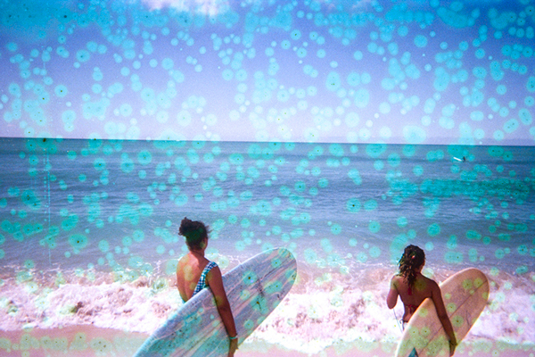 Two surfers overlooking the ocean