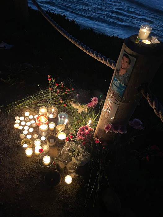 Lit candles and flowers in memoriam of Hamzah Alsaudi