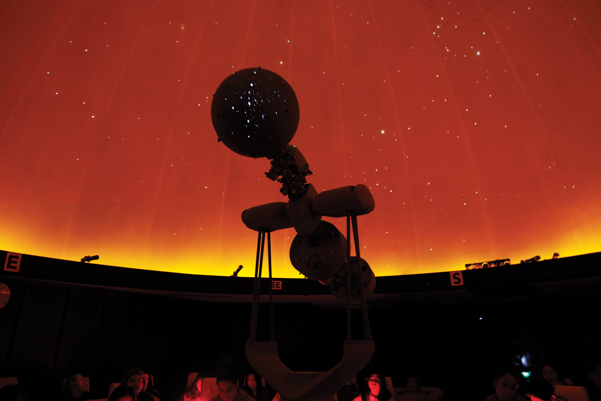 silhouette of a planetarium with a red horizon in the background