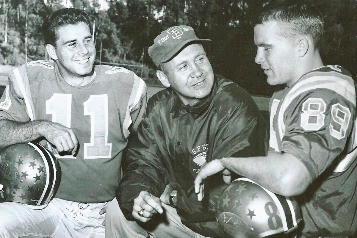 Vic Rowen with 2 football players