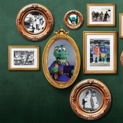 a green wall with a collage of picture frames showing Alli Gator throughout the years