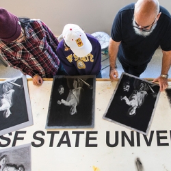 Top down view of professor working with students with art